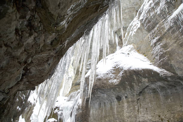 istock Frozen waterfall with icicles seen in the parkFrozen waterfall with icicles seen in the park 928068690