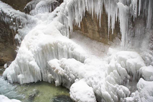 istock Frozen waterfall with icicles seen in the parkFrozen waterfall with icicles seen in the park 928068694