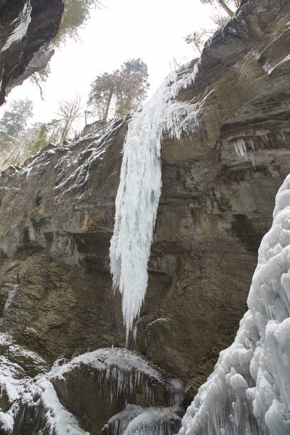 istock Frozen waterfall with icicles seen in the parkFrozen waterfall with icicles seen in the park 928068700