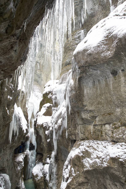 istock Frozen waterfall with icicles seen in the parkFrozen waterfall with icicles seen in the park 928068702