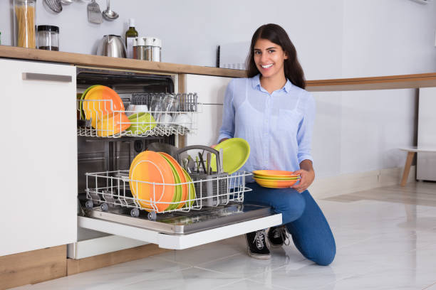 istock Woman Arranging Plates In Dishwasher 928068934
