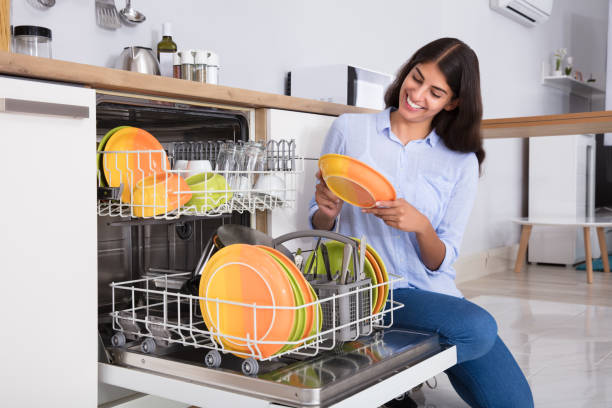 istock Woman Arranging Plates In Dishwasher 928068948