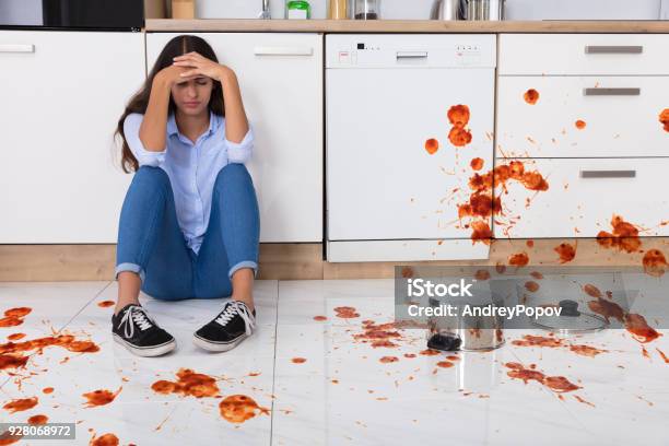 Woman Sitting On Kitchen Floor With Spilled Food Stock Photo - Download Image Now - Kitchen, Messy, Dirty