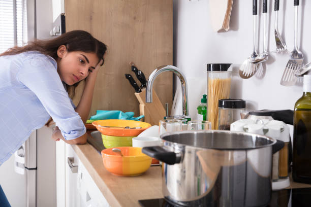 istock Woman Standing Near Kitchen Sink Looking At Utensils 928068988