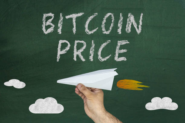 istock Bitcoin Price Boosts concept with hand holding paper plane on chalkboard 928069016