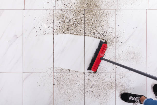 Broom Cleaning Dirt On Tiled Floor High Angle View Of Broom Cleaning Dirt On Tiled Floor At Home sweeping photos stock pictures, royalty-free photos & images