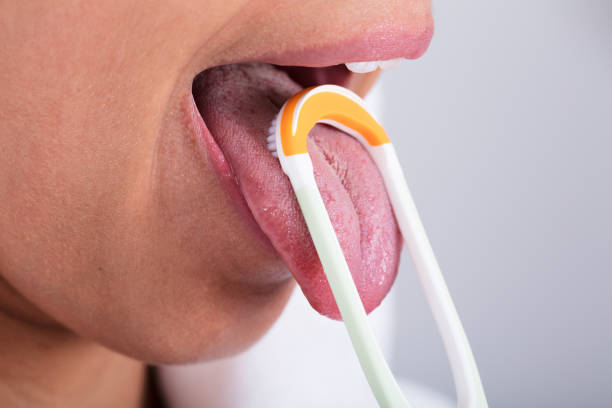 close up woman brushing teeth with toothbrush