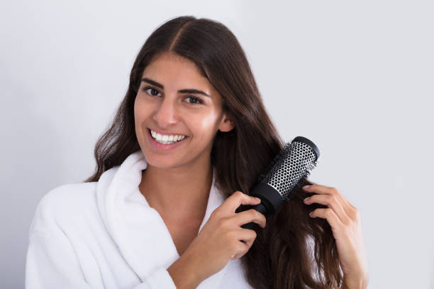 istock Happy Woman In Bathrobe Combing Hair 928069628