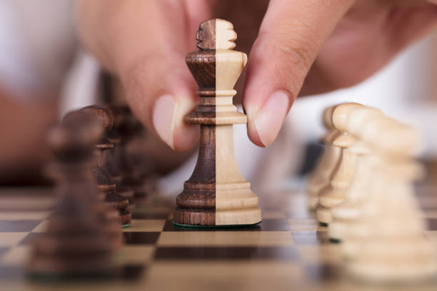 istock Person Hand Playing Chess And Holding King Chess Piece 928069818