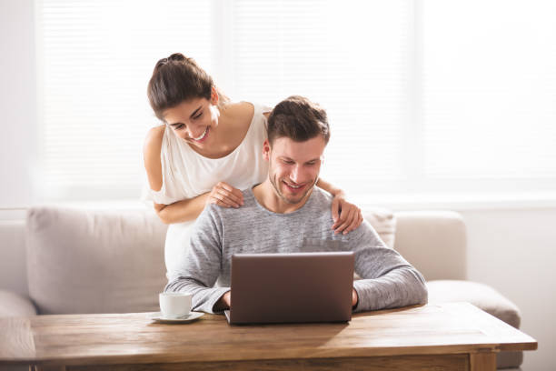 istock Smiling Couple Looking At Laptop 928073724