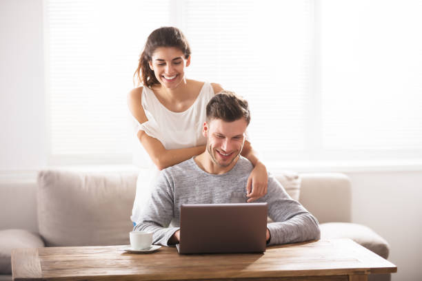 istock Smiling Couple Looking At Laptop 928073726