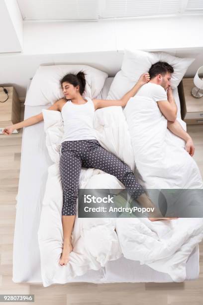 Young Woman Sleeping Beside Her Husband Stock Photo - Download Image Now - Adult, Adults Only, Bed - Furniture