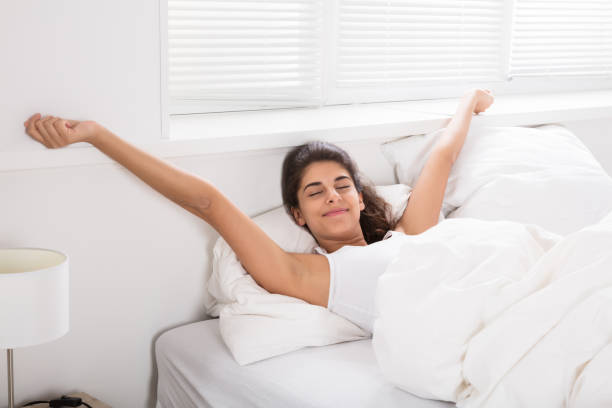 istock Smiling Woman On Bed Wake Up 928074396