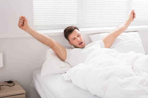 istock Man Stretch His Hand After Wake Up 928074398