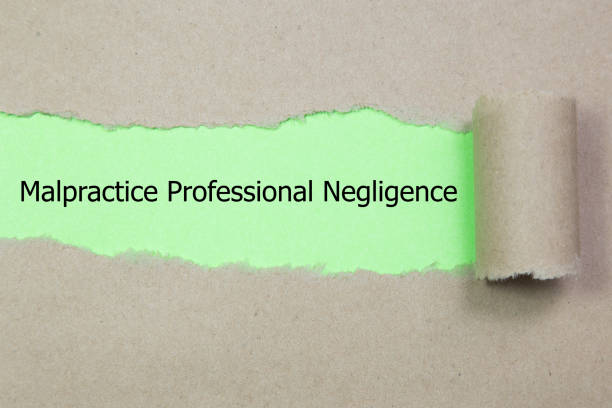 istock Text Malpractice Professional Negligence appearing behind ripped paper. 928074474
