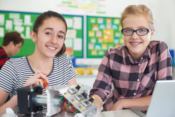 istock Portrait Of Female Pupils Studying Robotics In Science Lesson 928074578