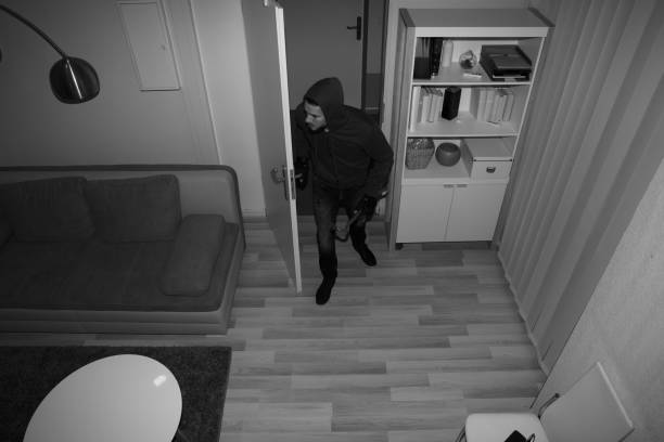 Robber Entering In House High Angle View Of A Robber Entering In Vacant House burglar stock pictures, royalty-free photos & images