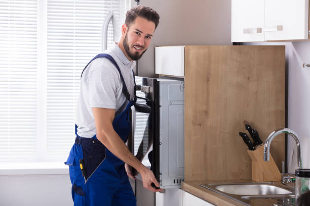 istock Male Electrician Fixing Oven 928076874