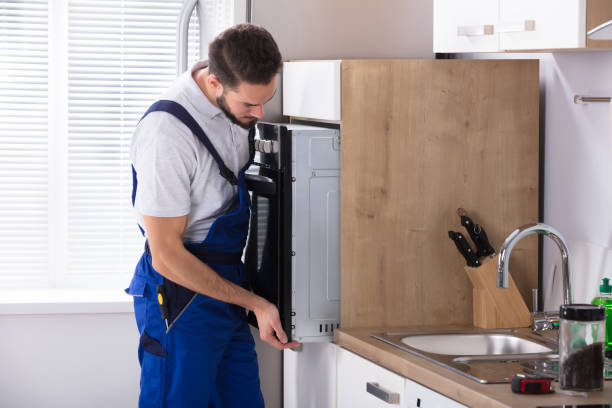 istock Male Electrician Fixing Oven 928076876