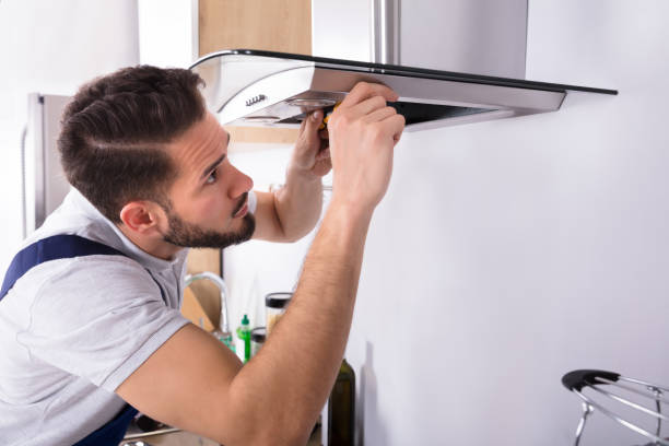 istock Electrician Repairing Kitchen Extractor Filter 928076934