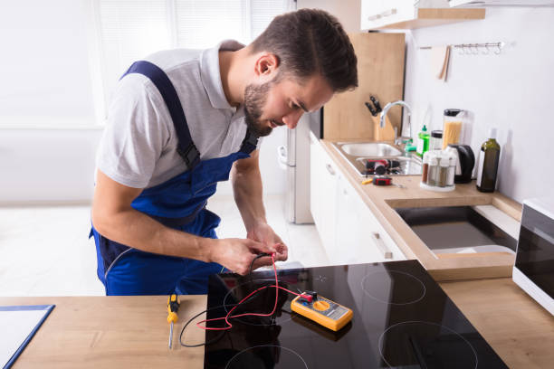 istock Young Repairman Fixing Induction Stove 928076958