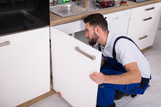 istock Handyman Fixing Sink Door 928076970