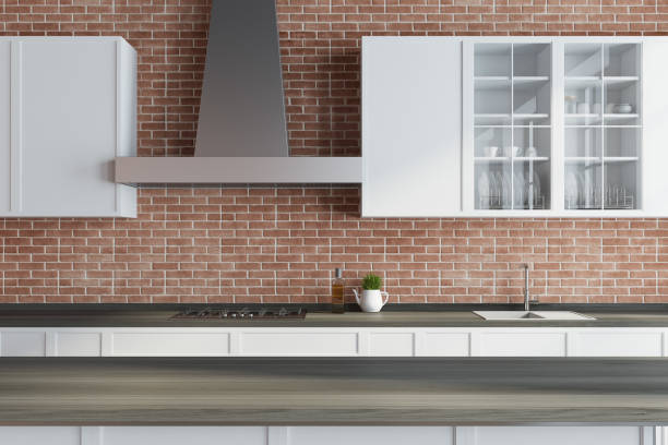 istock Modern brick kitchen, white countertops, wood 928077374