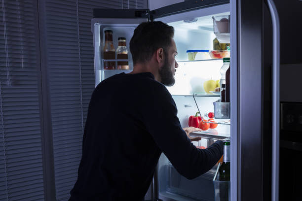 istock Man Looking At Food Kept In Refrigerator 928077484