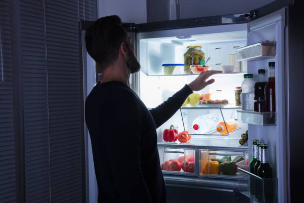 istock Man Looking At Food Kept In Refrigerator 928077488