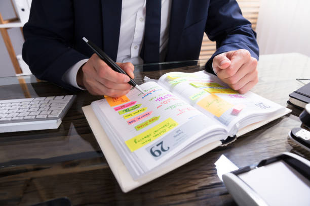 istock Businessperson Writing Schedule In Diary 928078138