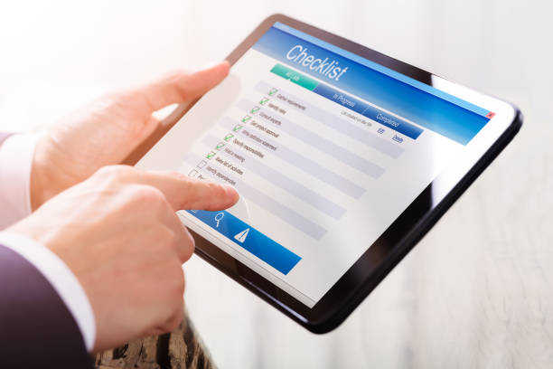 istock Businessperson Filling Checklist Form On Digital Tablet 928078212