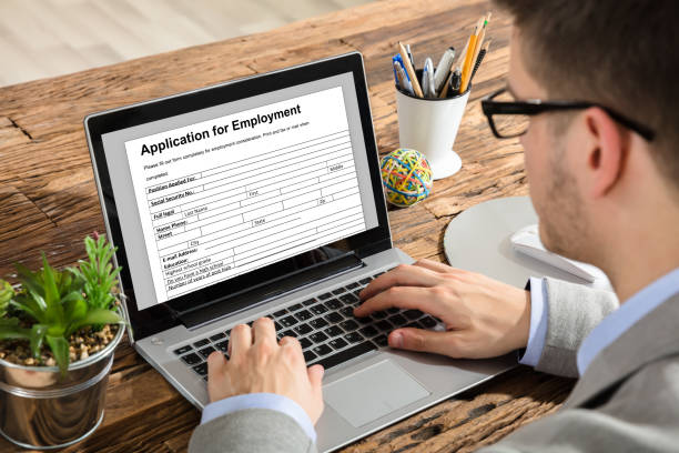 istock Businessman Filling Application For Employment Form On Laptop 928080694