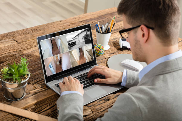 istock Businessman Checking CCTV Footage On Laptop 928080702