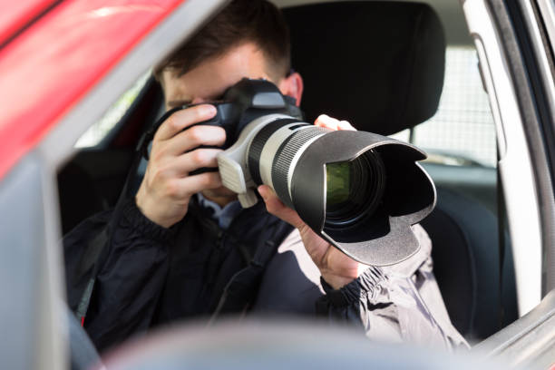 istock Private Detective Photographing With Slr Camera 928081048
