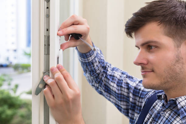 istock Repairman Fixing Window With Screwdriver 928081176