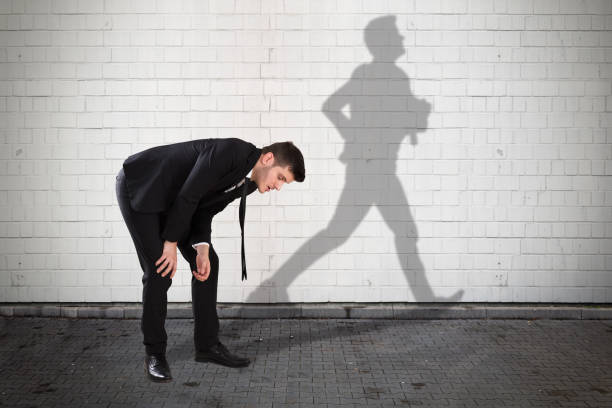 istock Businessman With Shadow Of Man Formed On Wall 928081634
