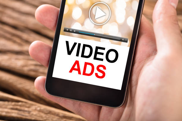 istock Hand Holding Mobile Phone With Text Video Ads On Screen 928081672