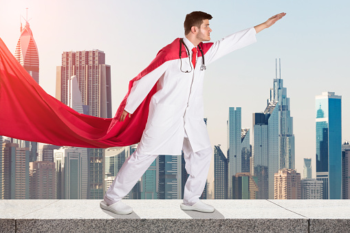 Young Superhero Doctor In Red Cape Against City Skyline