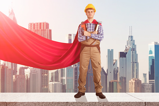 Superhero Repairman With Worktools Standing On Top Of Building