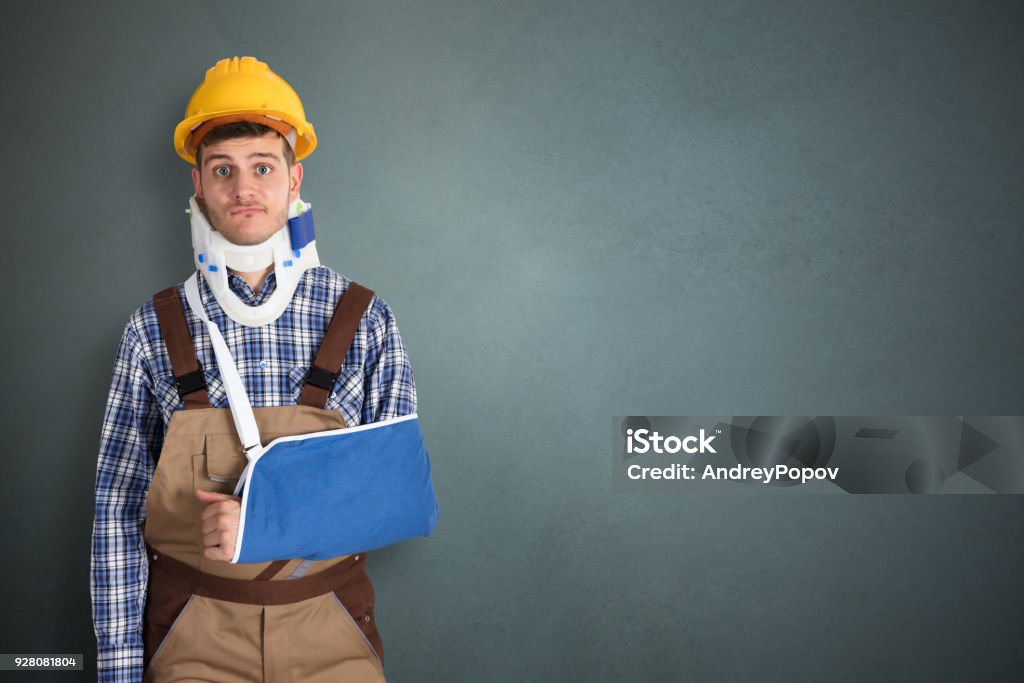 Handyman With Fractured Hand Portrait Of Young Male Handyman With Fractured Hand Physical Injury Stock Photo