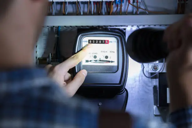 Photo of Finger Pointing To Electric Meter Reading
