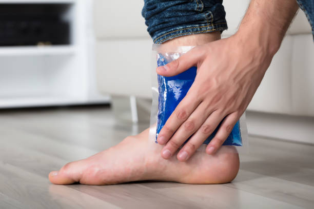 istock Person's Hand Holding Ice Gel Pack On Ankle 928084228