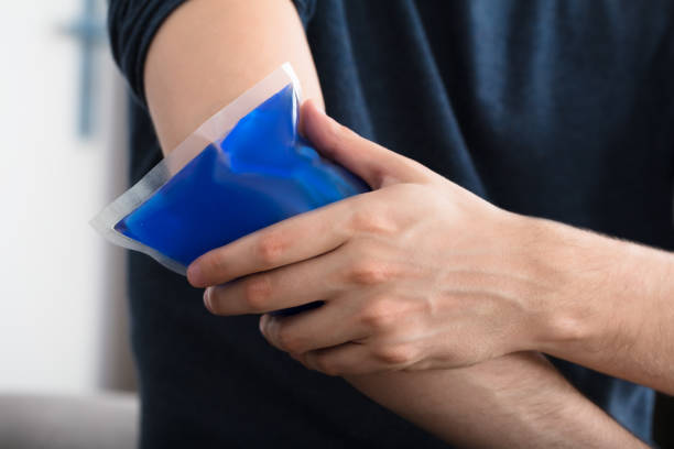 istock Person Applying Ice Gel Pack On An Injured Elbow 928084258