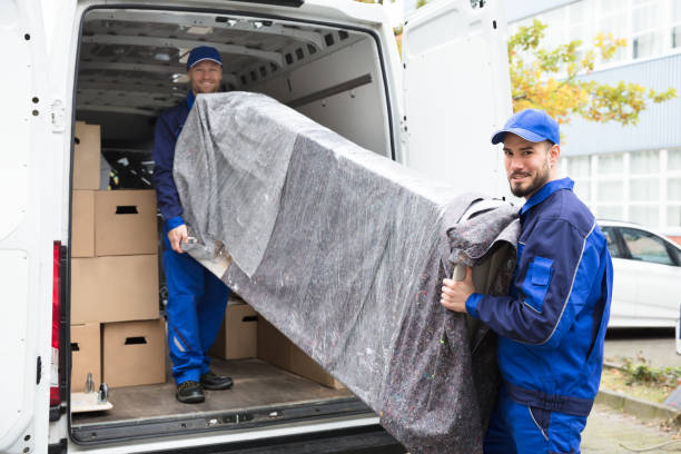 istock Two Delivery Men Unloading Furniture From Vehicle 928084804