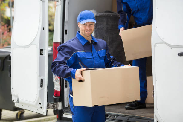 istock Delivery Man Carrying Cardboard Box 928084814