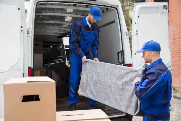 istock Two Male Worker Unloading Furniture From Truck 928084842