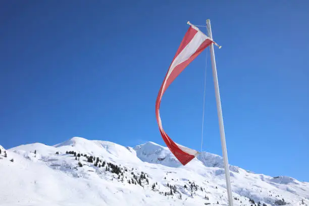 Austrian Flag near Hut at Ski Resort in Arlberg Mountains. Austria