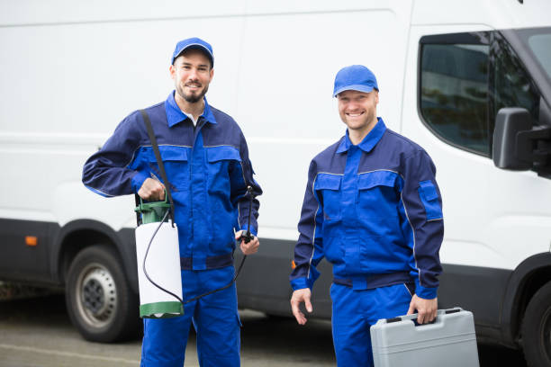 Portrait Of Two Pest Control Workers Portrait Of Two Happy Male Pest Control Workers With Toolbox exterminator photos stock pictures, royalty-free photos & images