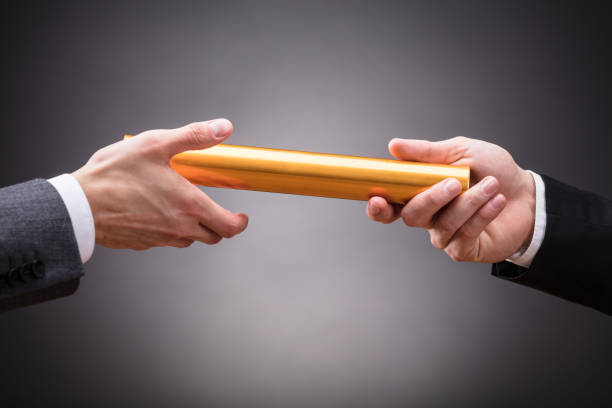 istock Person Passing Baton To Businessperson 928085608