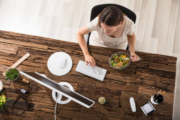 istock Young Woman Eating Salad 928086436